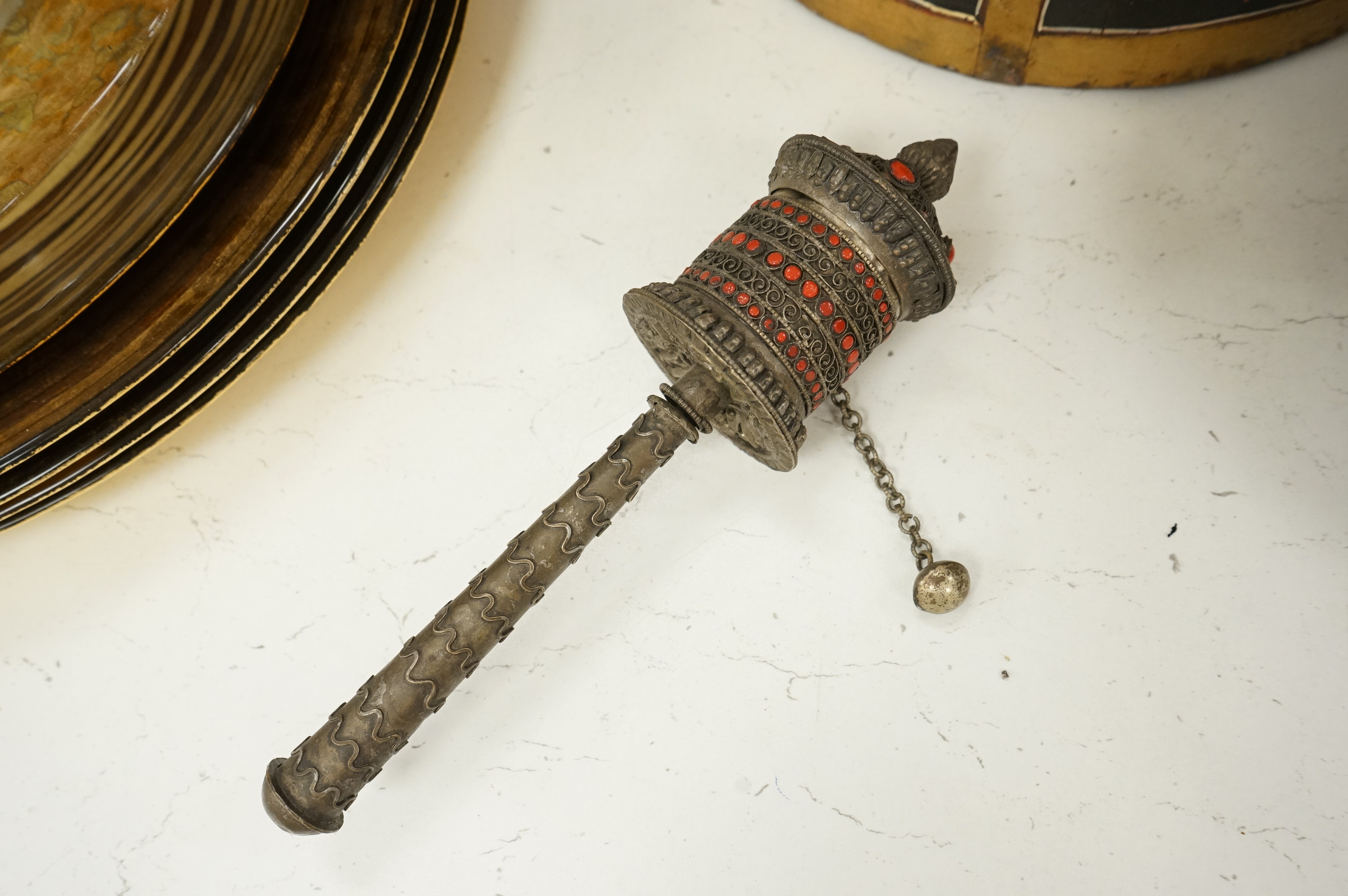 A collection of tribal and Asian collectables including a Tibetan prayer wheel, carvings, etc.